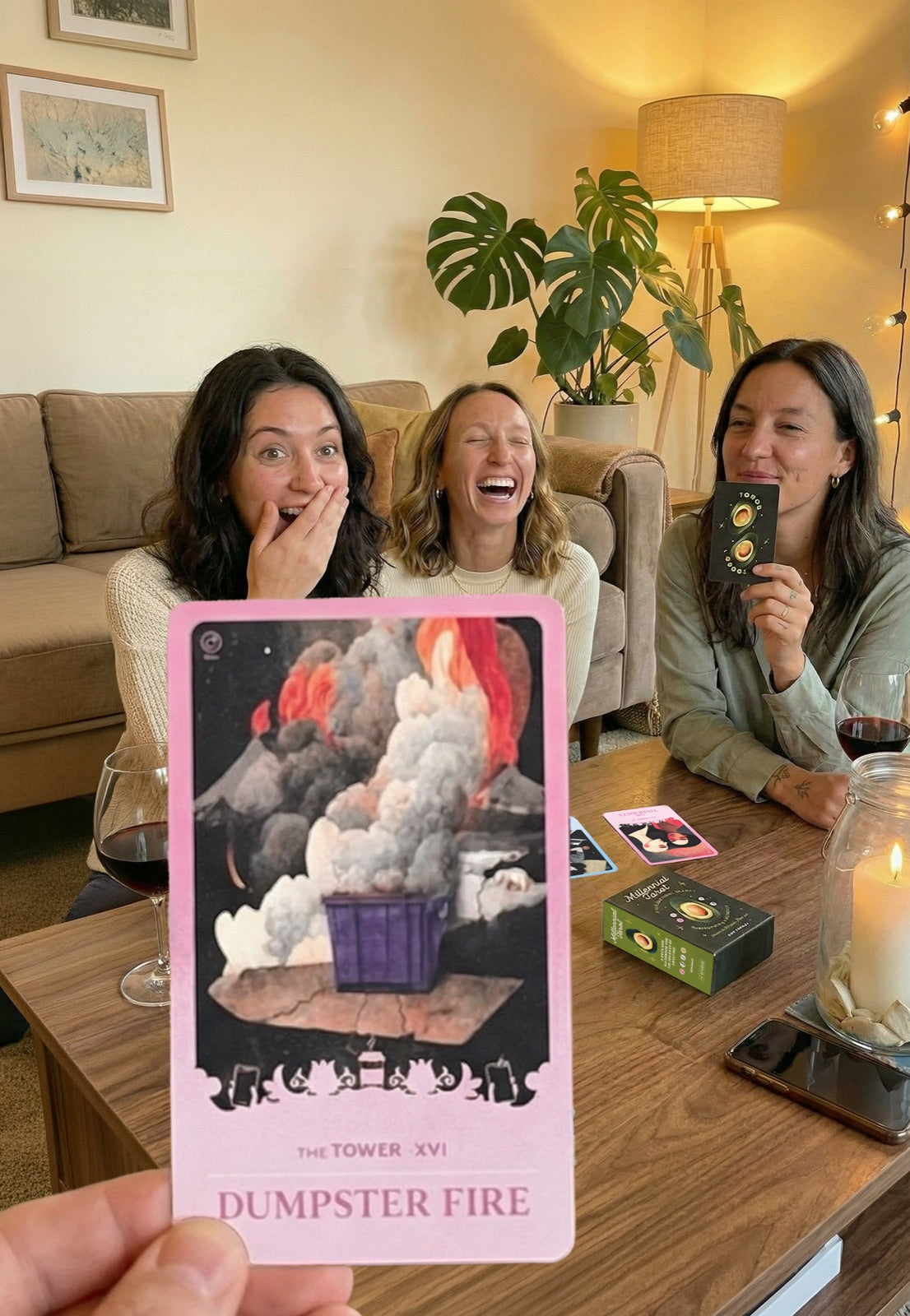 Friends pulling cards together on the couch